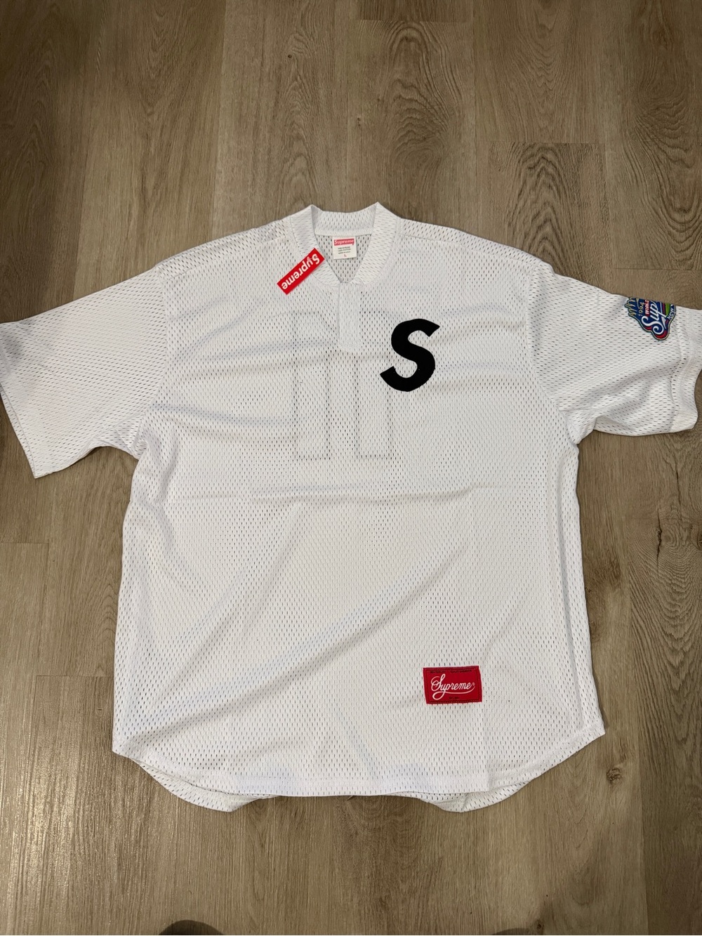 Supreme White Mesh Jersey with Black 'S' Chest Logo and Red Tags